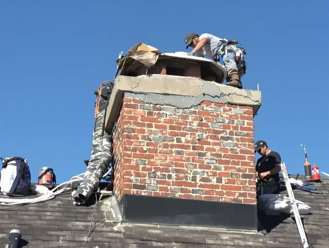 Bedford Heights Chimney Sweep installing a custom chimney crown in Bedford Heights, OH