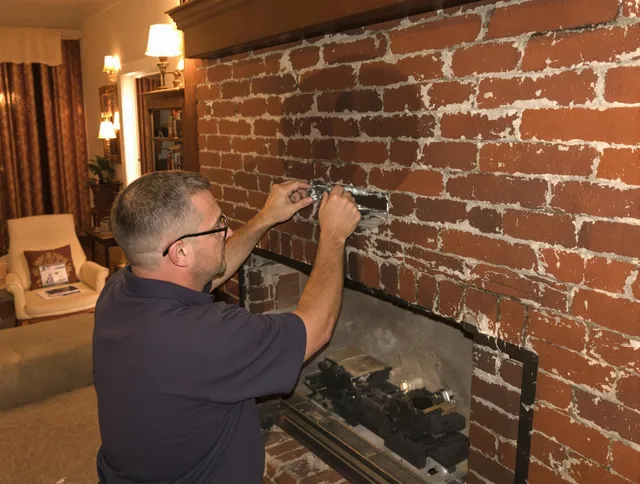 Bedford Heights Chimney Sweep expert fixing a fireplace in Bedford Heights, OH